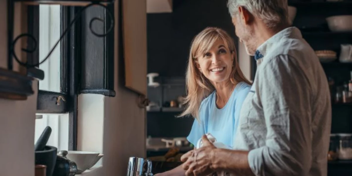 A couple smiling and talking together.