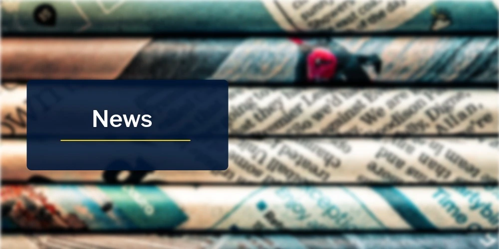 Blurred stack of newspapers with visible headlines and print, featuring a blue overlay panel displaying the word 'News'.