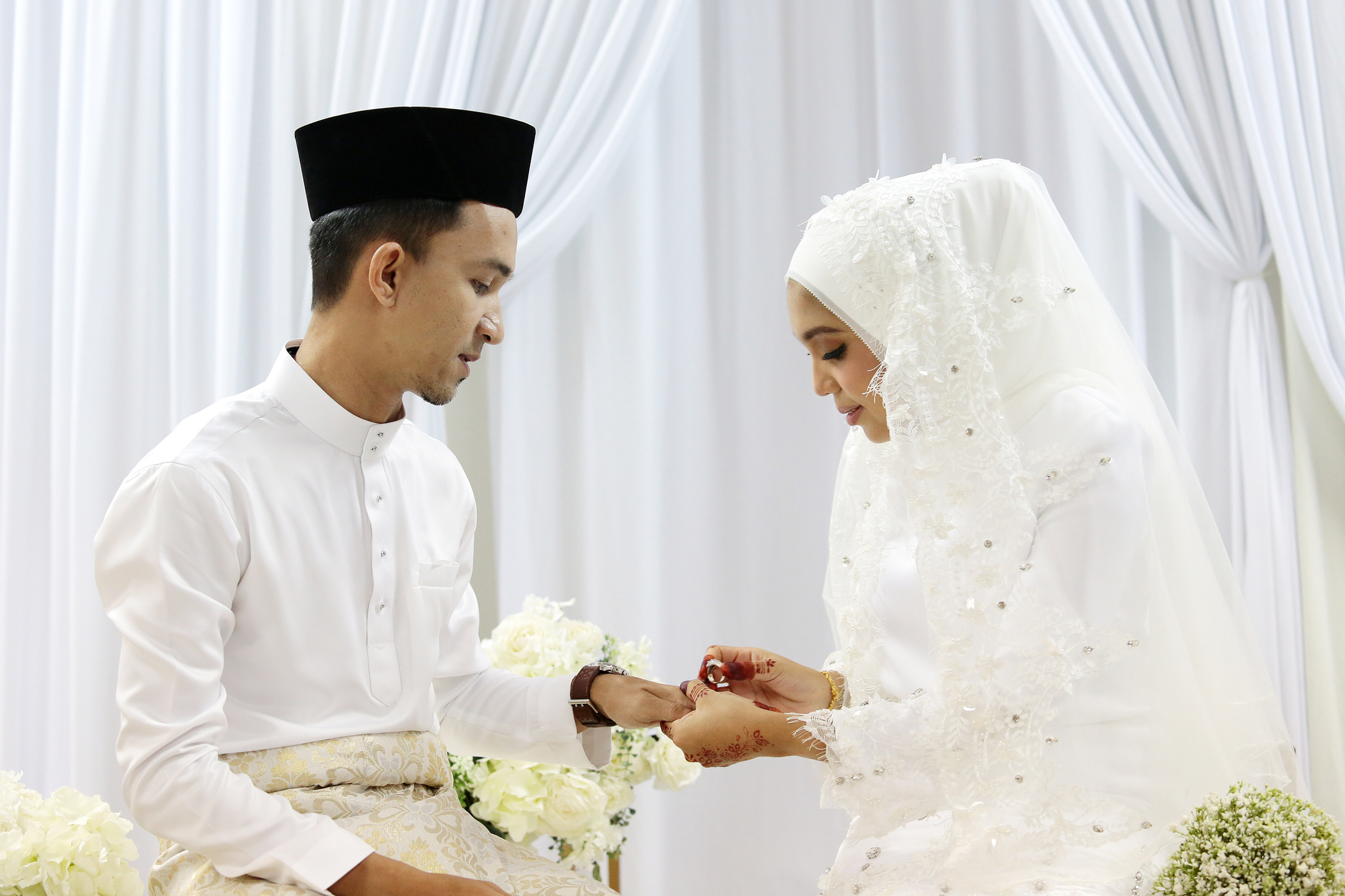 Bride and groom exchanging rings at a Nikah wedding ceremony