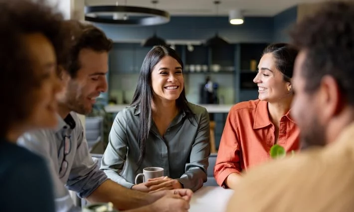 Family law solicitors smiling in an informal team meeting