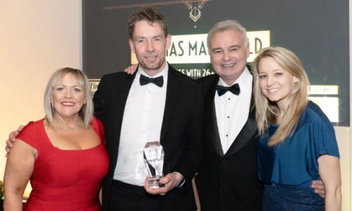 Thomas Mansfield receiving Times of Tunbridge Wells award for best business. Neill Thomas, Managing Director of Thomas Mansfield, pictured holding trophy. Accompanied by Emma Howlett, Head of Wills & Probate (on right) and awards presenters.
