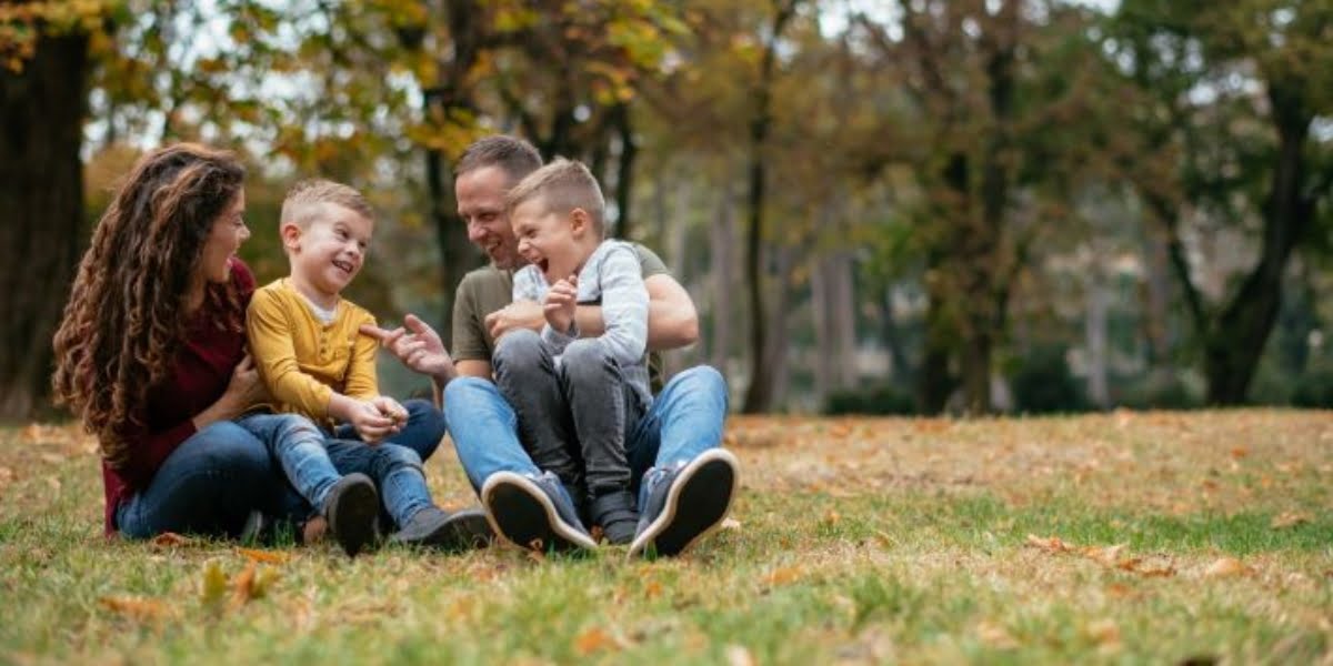 A smiling family spending time together in the park.