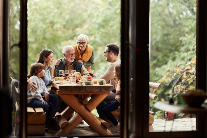Grandparents enjoying a family meal with their children and grandchildren.