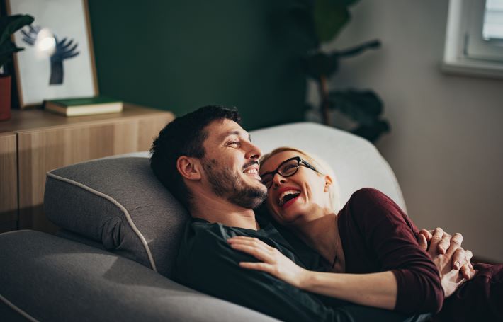 A couple relaxing on the sofa at home.
