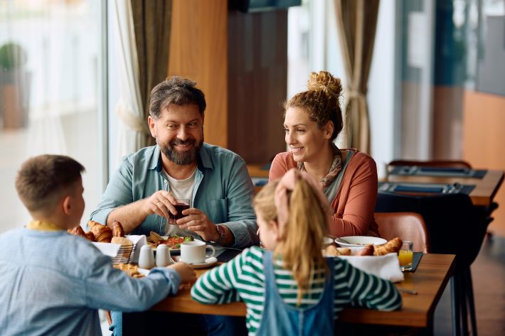 A family enjoying a meal out at a restaurant.
